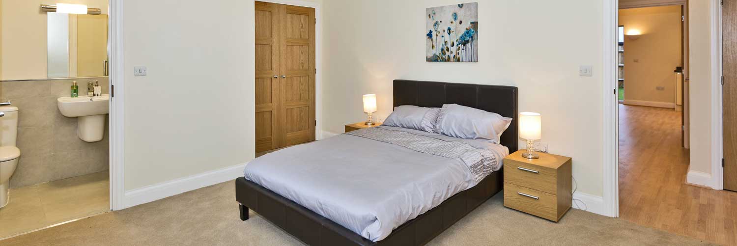 Typical bright bedroom with classic white ensuite at Langborough Court